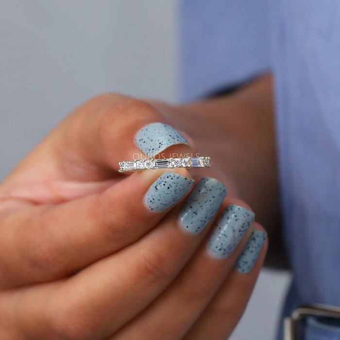 close view of baguette and round lab diamond half eternity band ring yellow gold