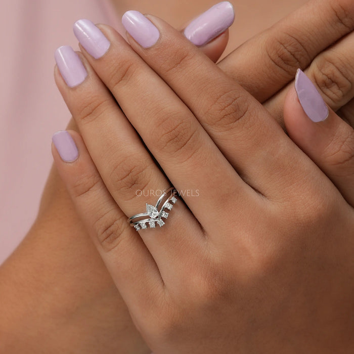 Cross hand finger front view, crafted pear shaped ring with 14k white gold. 