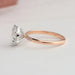 side view of rose-cut round diamond solitaire accent ring with rose gold band