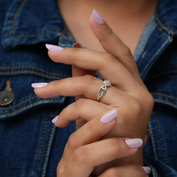 In finger side look of fancy yellow round cut lab made diamond engagement ring